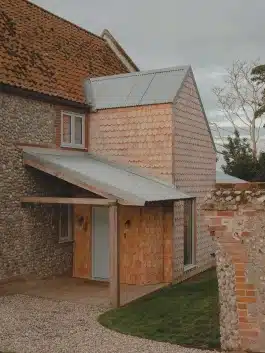 The north extension rising like a totem to signal the entrance and articulate the north elevation Alexander Hills Architects